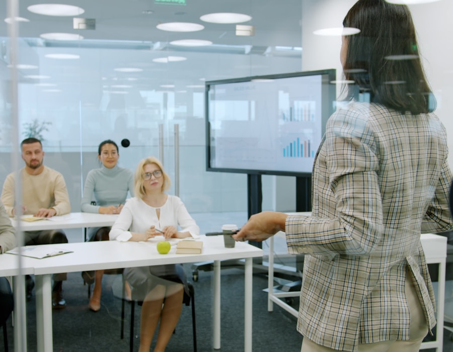 A trainer presenting to colleagues in a meeting room
