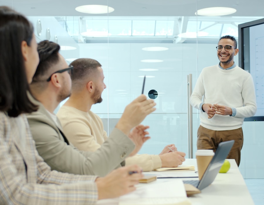 Colleagues in a training session, one asking a question while the presenter explains